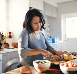 a woman preparing food in a kitchen