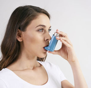 a young woman with an asthma inhaler