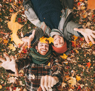 a young couple in autumn leaves