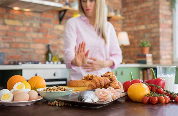 Woman having different food allergies