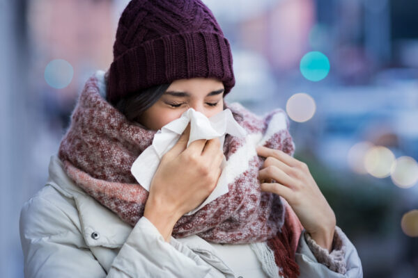 Woman blowing nose outdoor